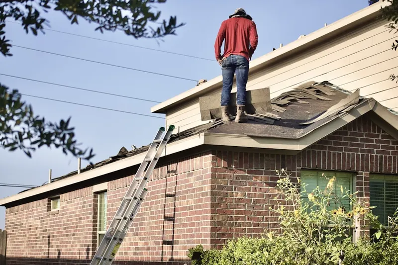 Professional roofer working on a residential roof in Eagle Bend